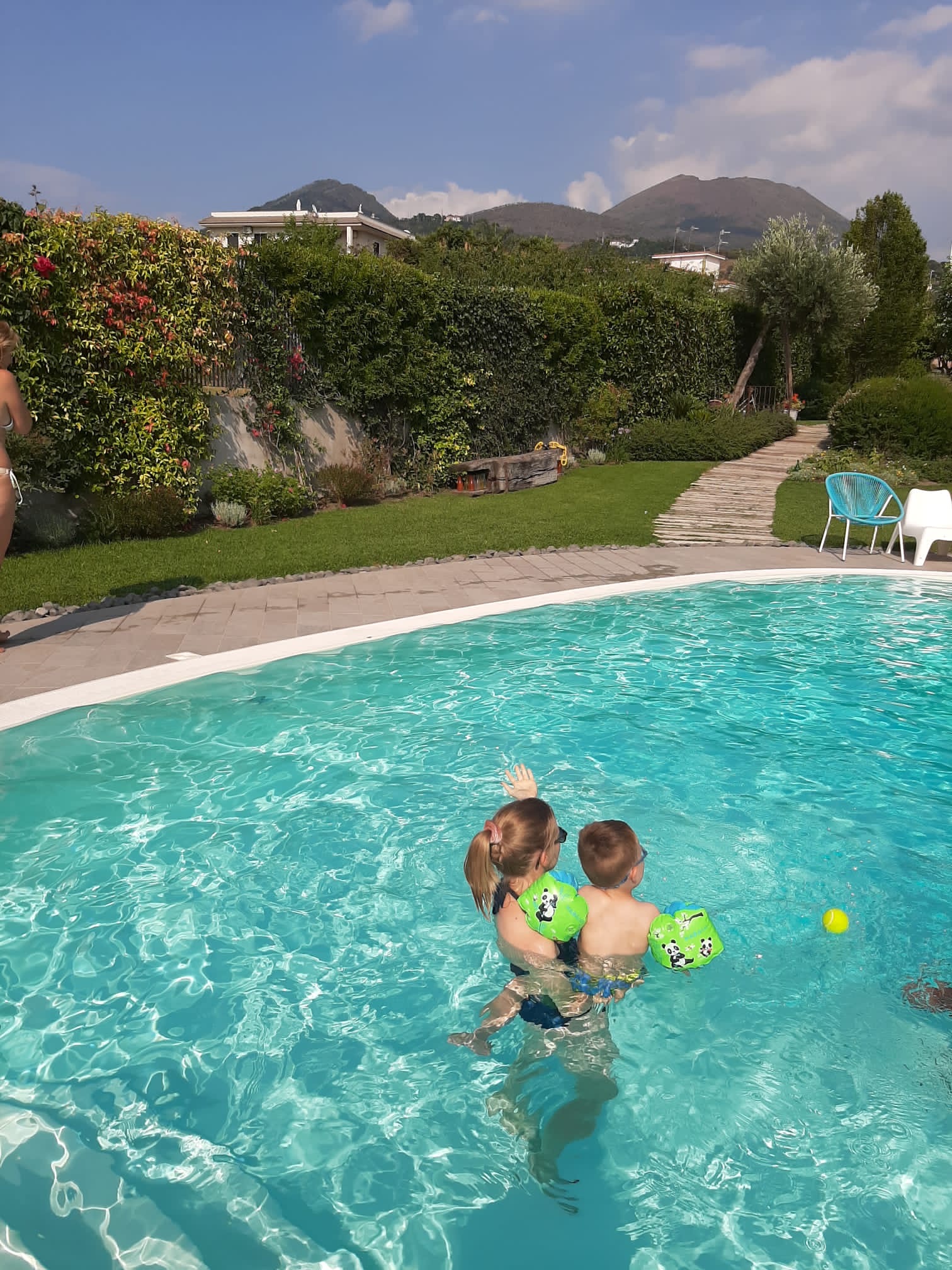 Travel blogger and son in pool in Ercolano